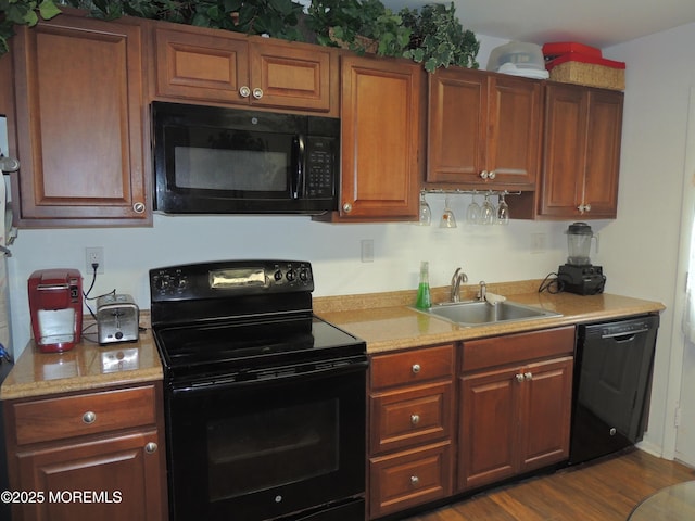 455A Chesterfield Ct, Manchester, NJ 08759 - kitchen featuring black appliances, light countertops, dark wood finished floors, and brown cabinets