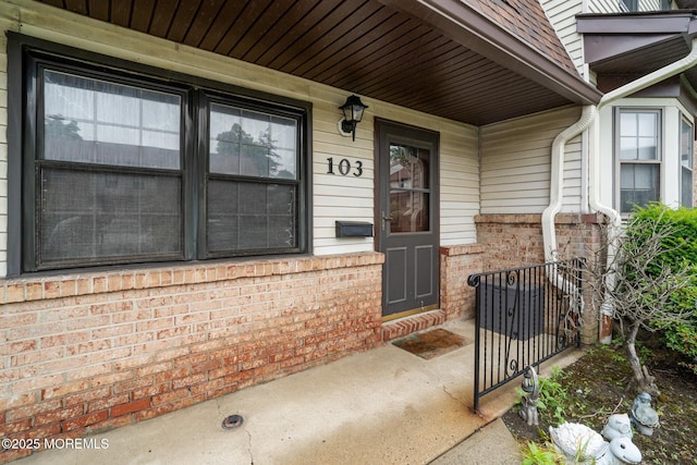 103 Village Green Way, Hazlet, NJ 07730 - view of exterior entry with brick siding and a porch
