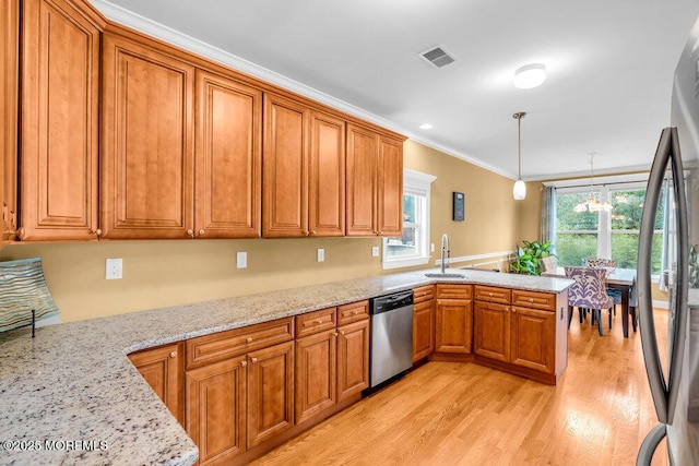 626 Anthony Ave, Toms River, NJ 08753 - kitchen featuring stainless steel appliances, a peninsula, brown cabinets, crown molding, and light wood-type flooring