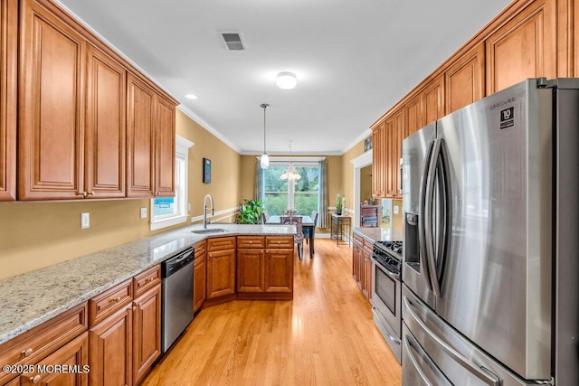 626 Anthony Ave, Toms River, NJ 08753 - kitchen featuring appliances with stainless steel finishes, brown cabinetry, light wood-type flooring, crown molding, and a peninsula