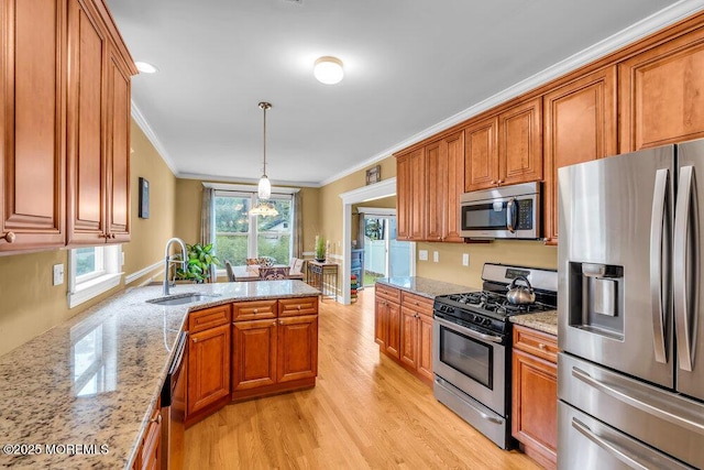 626 Anthony Ave, Toms River, NJ 08753 - kitchen featuring stainless steel appliances, ornamental molding, brown cabinets, and light wood finished floors