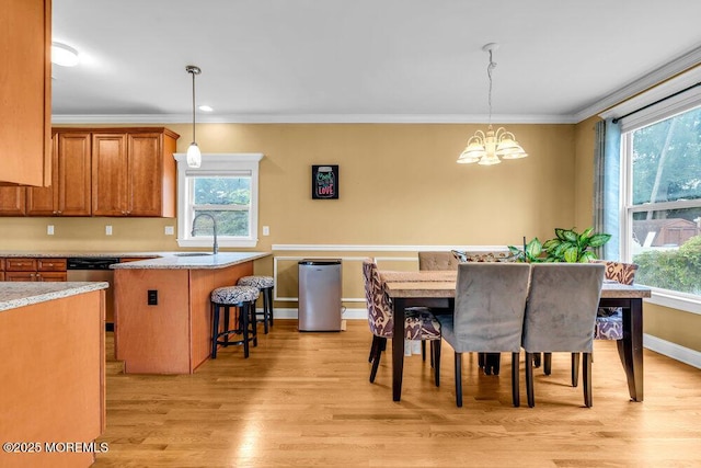 626 Anthony Ave, Toms River, NJ 08753 - dining room with healthy amount of natural light, a chandelier, light wood finished floors, and crown molding