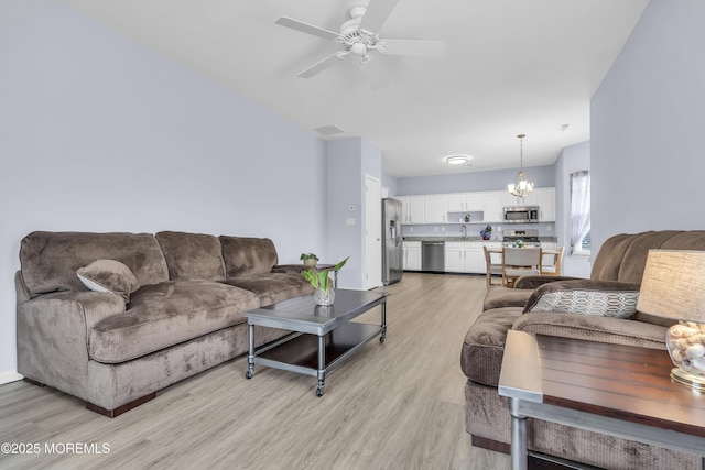 10 Ignatius Dr, Manchester, NJ 08759 - living room featuring light wood-style flooring, ceiling fan, and a chandelier