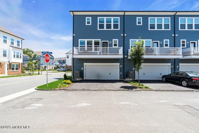 25 Signal Ave, Oceanport, NJ 07757 - back of house featuring driveway, an attached garage, and a residential view