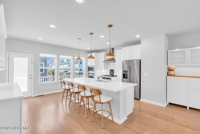 25 Signal Ave, Oceanport, NJ 07757 - kitchen with stainless steel appliances, a breakfast bar area, white cabinets, light wood-style flooring, and light countertops