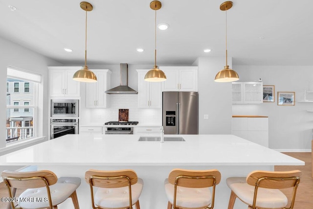 25 Signal Ave, Oceanport, NJ 07757 - kitchen with appliances with stainless steel finishes, wall chimney range hood, decorative backsplash, a kitchen breakfast bar, and a kitchen island with sink