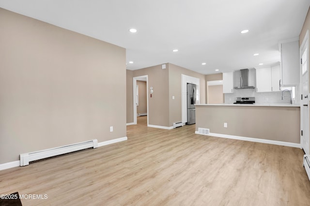 30 Stuyvesant Rd, Brick, NJ 08723 - unfurnished living room with a baseboard radiator, light wood finished floors, and recessed lighting