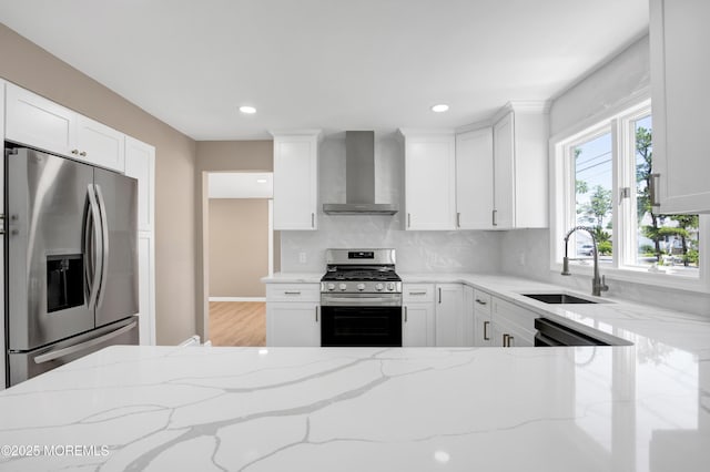 30 Stuyvesant Rd, Brick, NJ 08723 - kitchen with appliances with stainless steel finishes, wall chimney exhaust hood, decorative backsplash, light stone countertops, and white cabinets
