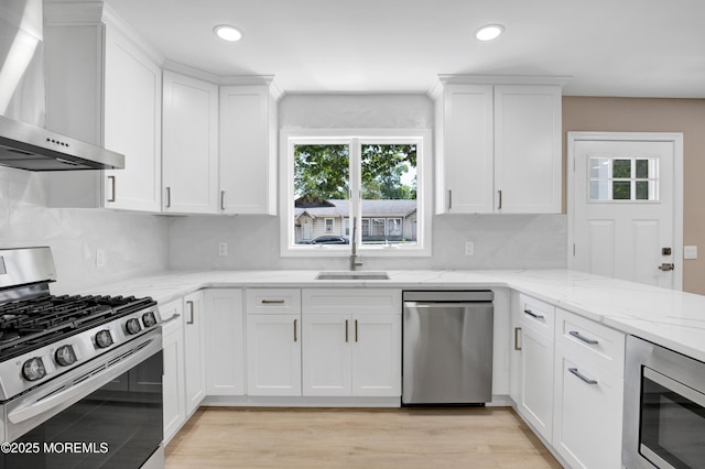 30 Stuyvesant Rd, Brick, NJ 08723 - kitchen with stainless steel appliances, wall chimney exhaust hood, white cabinets, recessed lighting, and tasteful backsplash