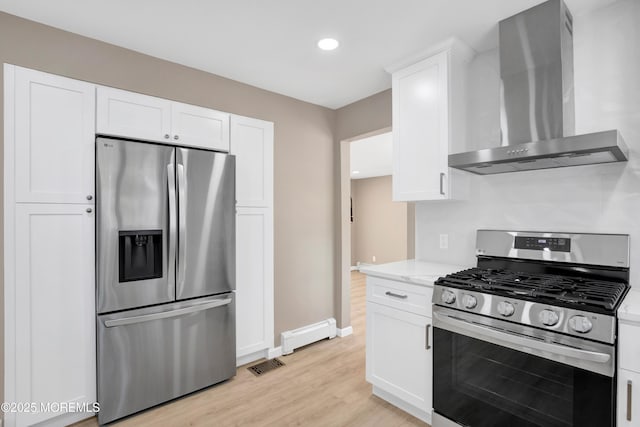 30 Stuyvesant Rd, Brick, NJ 08723 - kitchen with stainless steel appliances, wall chimney range hood, white cabinets, light wood-style floors, and a baseboard heating unit