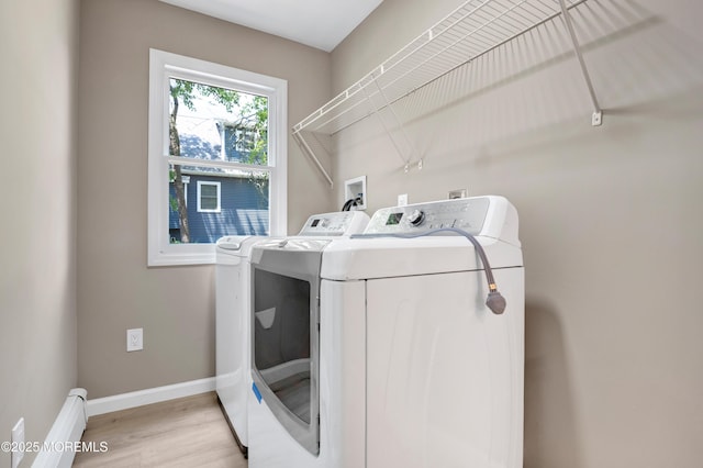 30 Stuyvesant Rd, Brick, NJ 08723 - laundry room with washing machine and clothes dryer, a baseboard radiator, and light wood-type flooring