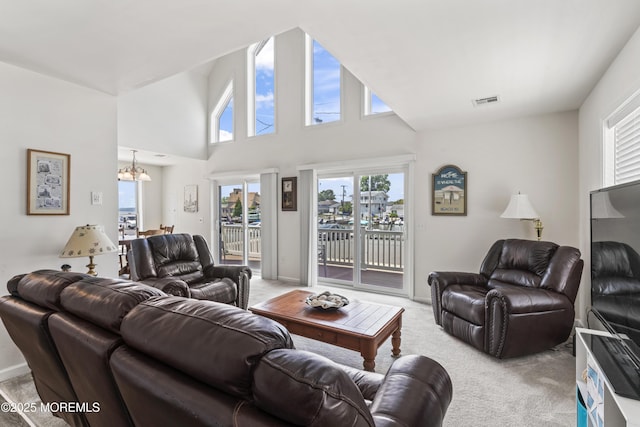 21 Seabreeze Rd, Toms River, NJ 08753 - living room featuring a chandelier, healthy amount of natural light, light carpet, and a towering ceiling