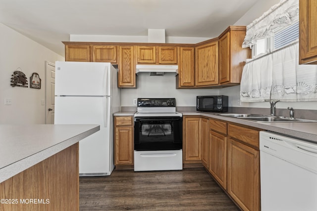 21 Seabreeze Rd, Toms River, NJ 08753 - kitchen featuring white appliances, under cabinet range hood, dark wood finished floors, brown cabinetry, and light countertops