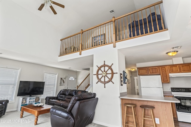 21 Seabreeze Rd, Toms River, NJ 08753 - living area featuring ceiling fan, a towering ceiling, carpet floors, and stairway