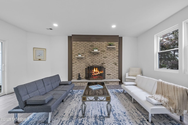 131 3rd St, Keyport, NJ 07735 - living room with wood finished floors, a brick fireplace, and recessed lighting