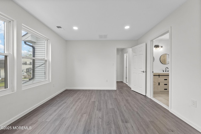 131 3rd St, Keyport, NJ 07735 - unfurnished bedroom featuring wood finished floors, recessed lighting, and connected bathroom