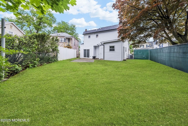 131 3rd St, Keyport, NJ 07735 - rear view of house featuring a fenced backyard, a patio area, and a chimney