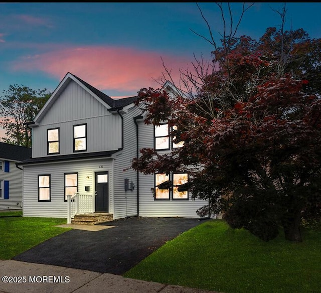 131 3rd St, Keyport, NJ 07735 - view of front of house with a lawn, board and batten siding, and asphalt driveway