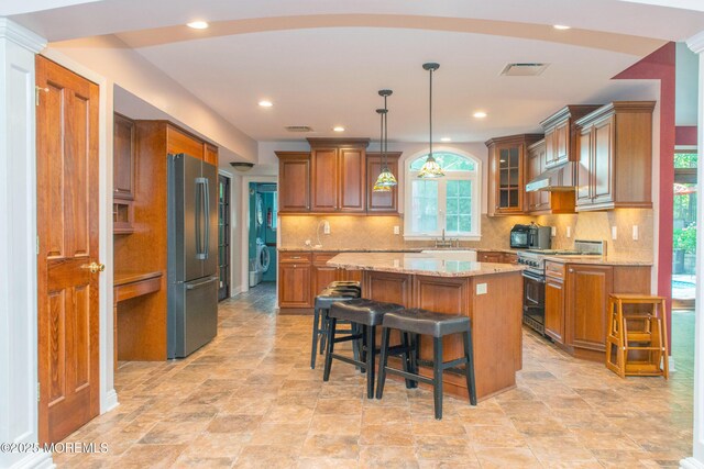 223 Kelly Lynn Ln, Brick, NJ 08724 - kitchen featuring high quality stove, freestanding refrigerator, brown cabinetry, a kitchen island, and recessed lighting