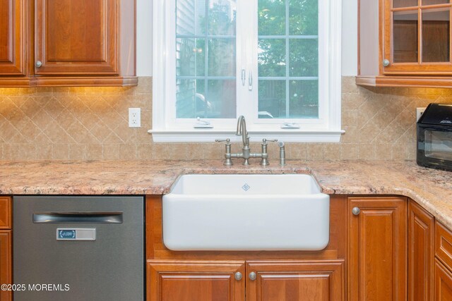 223 Kelly Lynn Ln, Brick, NJ 08724 - kitchen with dishwasher, light stone counters, brown cabinetry, tasteful backsplash, and glass insert cabinets