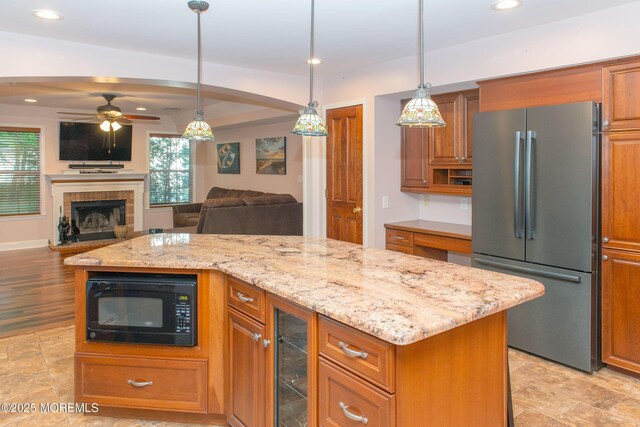 223 Kelly Lynn Ln, Brick, NJ 08724 - kitchen with freestanding refrigerator, black microwave, wine cooler, ceiling fan, and light stone countertops