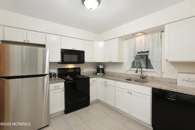 100 Courtshire Dr, Brick, NJ 08723 - kitchen with black appliances, white cabinetry, and light stone countertops