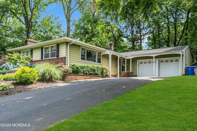384 Gerry Rd, North Brunswick, NJ 08902 - single story home with a chimney, asphalt driveway, an attached garage, a front yard, and brick siding