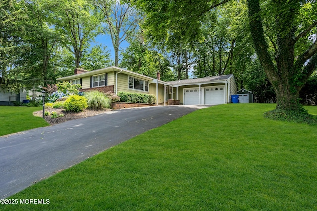 384 Gerry Rd, North Brunswick, NJ 08902 - view of front of property featuring a chimney, asphalt driveway, an attached garage, and a front yard