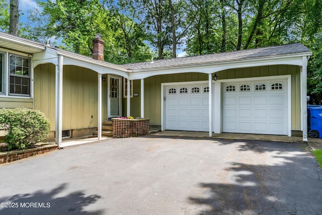 384 Gerry Rd, North Brunswick, NJ 08902 - view of property exterior with driveway, a chimney, and board and batten siding