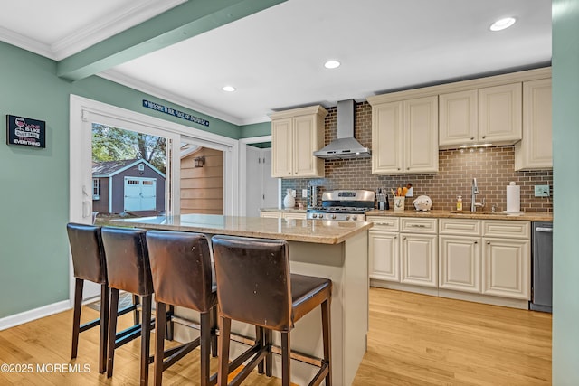 384 Gerry Rd, North Brunswick, NJ 08902 - kitchen with wall chimney range hood, stainless steel appliances, a breakfast bar area, light wood-type flooring, and crown molding