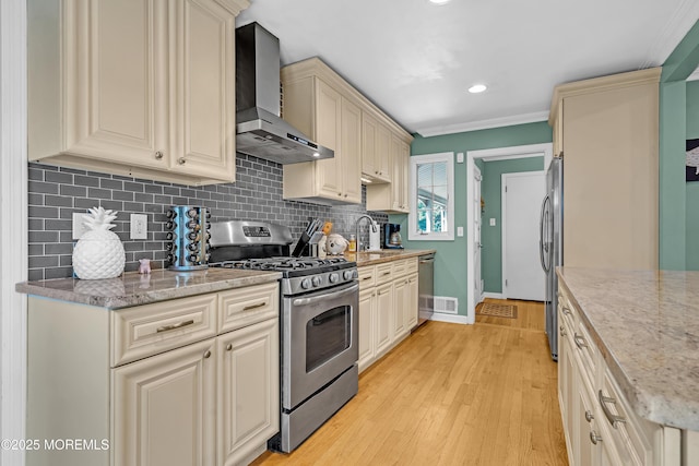 384 Gerry Rd, North Brunswick, NJ 08902 - kitchen featuring appliances with stainless steel finishes, wall chimney exhaust hood, backsplash, cream cabinetry, and ornamental molding