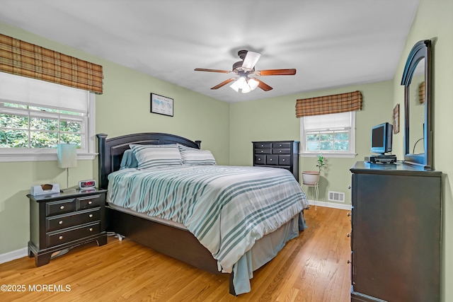 384 Gerry Rd, North Brunswick, NJ 08902 - bedroom with multiple windows, light wood finished floors, and a ceiling fan