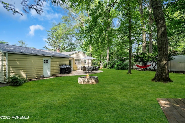 384 Gerry Rd, North Brunswick, NJ 08902 - view of grassy yard with an outdoor fire pit and a patio