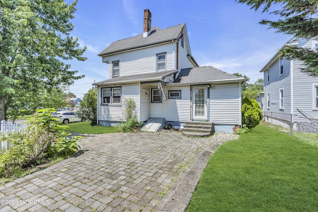 300 Atkins Ave, Neptune Township, NJ 07753 - back of property featuring a chimney, a yard, roof with shingles, and a patio area