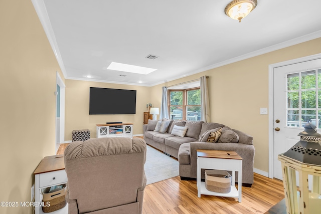 1425 Birmingham Ave, Toms River, NJ 08757 - living room with ornamental molding, a skylight, plenty of natural light, and light wood finished floors