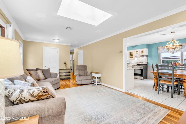 1425 Birmingham Ave, Toms River, NJ 08757 - living area featuring light wood-style flooring, a chandelier, ornamental molding, and a skylight