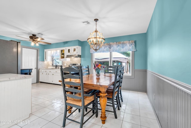 1425 Birmingham Ave, Toms River, NJ 08757 - dining room with a chandelier, a wainscoted wall, plenty of natural light, a ceiling fan, and light tile patterned floors