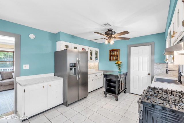 1425 Birmingham Ave, Toms River, NJ 08757 - kitchen with stainless steel appliances, ceiling fan, tasteful backsplash, white cabinetry, and light tile patterned flooring