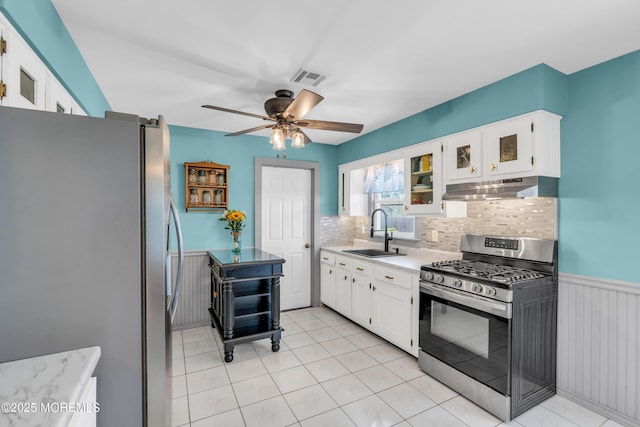 1425 Birmingham Ave, Toms River, NJ 08757 - kitchen featuring stainless steel appliances, under cabinet range hood, decorative backsplash, white cabinets, and ceiling fan