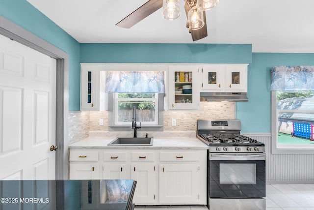 1425 Birmingham Ave, Toms River, NJ 08757 - kitchen featuring stainless steel gas stove, under cabinet range hood, white cabinets, light stone counters, and glass insert cabinets