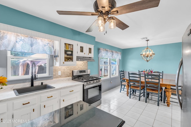 1425 Birmingham Ave, Toms River, NJ 08757 - kitchen featuring stainless steel appliances, under cabinet range hood, white cabinetry, tasteful backsplash, and glass insert cabinets