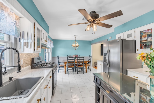 1425 Birmingham Ave, Toms River, NJ 08757 - kitchen featuring appliances with stainless steel finishes, white cabinets, backsplash, a ceiling fan, and glass insert cabinets