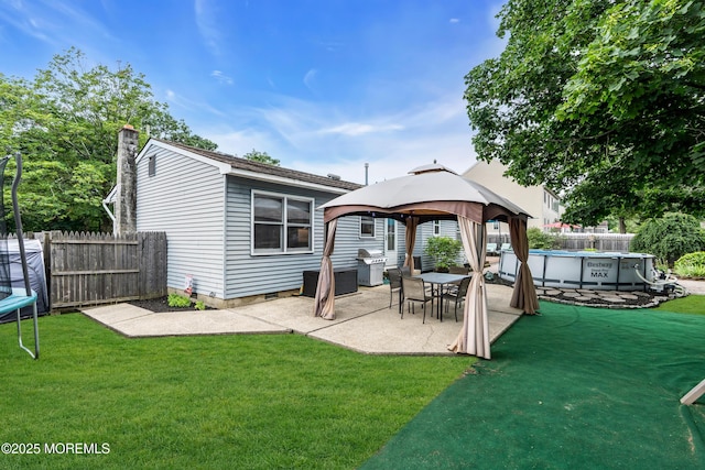 1425 Birmingham Ave, Toms River, NJ 08757 - rear view of house featuring a gazebo, a patio area, a trampoline, and a chimney