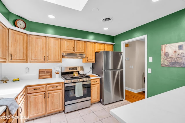 106 Northumberland Dr, Toms River, NJ 08757 - kitchen featuring appliances with stainless steel finishes, under cabinet range hood, a skylight, light countertops, and light tile patterned floors