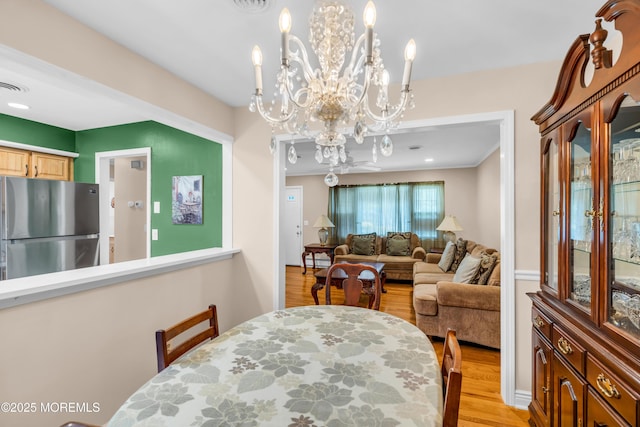 106 Northumberland Dr, Toms River, NJ 08757 - dining area with light wood-type flooring and a chandelier