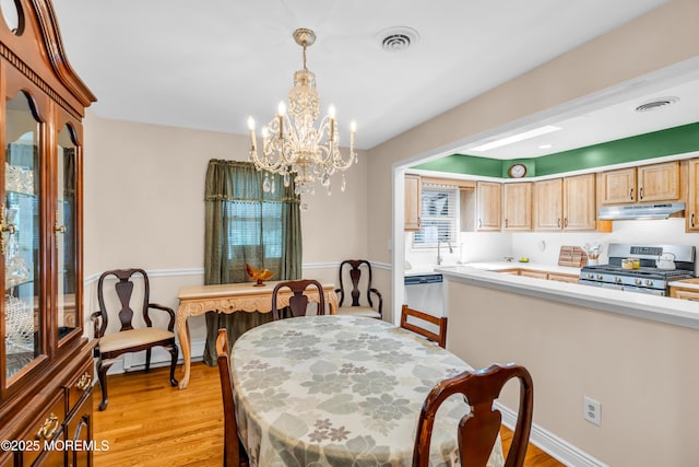 106 Northumberland Dr, Toms River, NJ 08757 - dining area with a chandelier and light wood-style floors