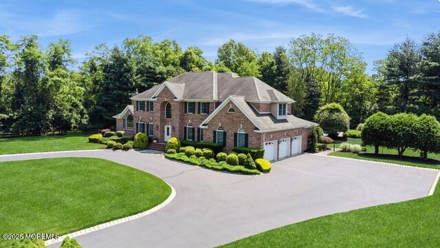 9 Wide Horizons Dr, Colts Neck, NJ 07722 - colonial house featuring driveway, brick siding, and a front lawn