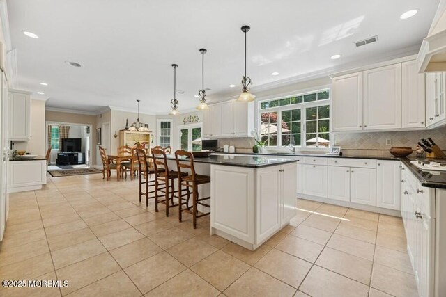 9 Wide Horizons Dr, Colts Neck, NJ 07722 - kitchen with crown molding, light tile patterned floors, backsplash, dark countertops, and recessed lighting