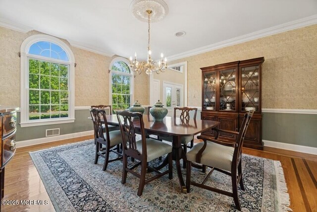 9 Wide Horizons Dr, Colts Neck, NJ 07722 - dining area with a chandelier, wood finished floors, crown molding, and wallpapered walls