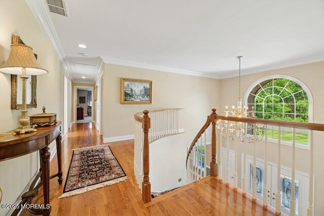 9 Wide Horizons Dr, Colts Neck, NJ 07722 - corridor with attic access, an upstairs landing, wood finished floors, a chandelier, and crown molding